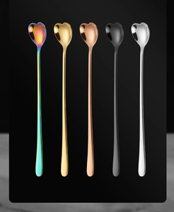 Macro view of five heart-shaped long handle spoons in various polished metallic finishes
