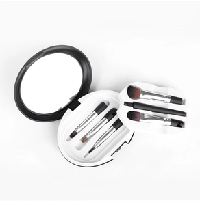 Detailed view of 5-piece portable makeup brush set with built-in mirror and compact round case