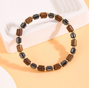 Sleek hematite and wooden beaded bracelet for men on a professional display stand