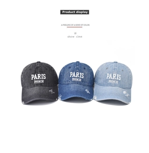 Detailed view of PARIS embroidery and distressed denim texture on three baseball caps