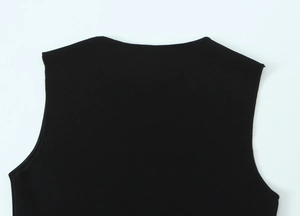 Close-up of black ribbed knit neckline and shoulder detail on a sleeveless top