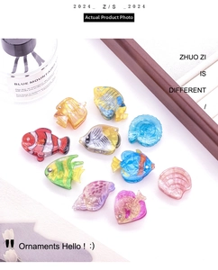 Macro detail of acrylic sea shell and tropical fish hair clips with sparkling rhinestones