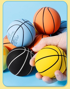 Close-up of colorful mini elastic rubber basketball toys being squeezed by hand
