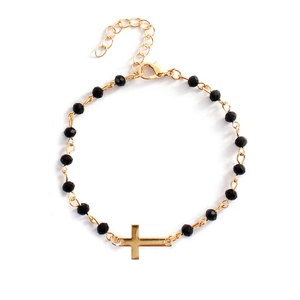 Minimalist gold chain bracelet featuring black beads and a horizontal cross pendant