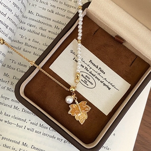 Elegant maple leaf necklace set with pearls and crystals in a luxury jewelry box