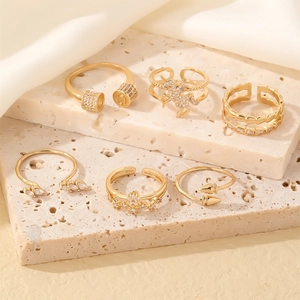 Set of 6 gold adjustable rings featuring crystal unicorn and crown designs on stones