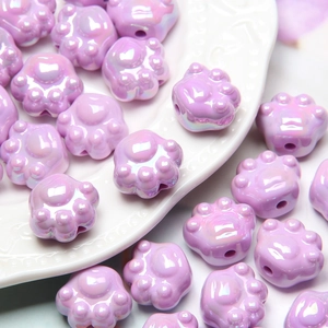 Macro shot of purple cat paw acrylic beads with pearlescent finish for DIY jewelry