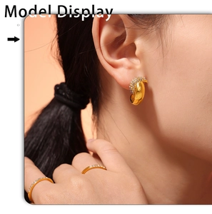 Macro shot of 18k gold plated crescent earring with zircon inlay on model display