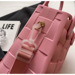 Detail shot of the pink EVA square bag showing the textured finish and strap hook