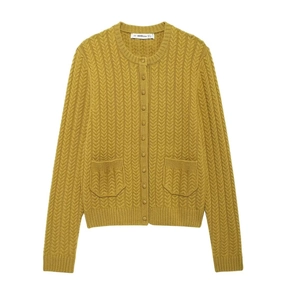 Detail of a ginger yellow knit cardigan featuring a round neck, gold buttons and front pockets