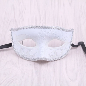 Close-up of white Venetian half face mask with silver lace trim and embossed patterns