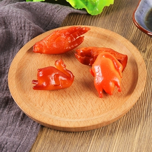 Realistic roasted chicken and pig trotter resin keychains displayed on a wooden plate