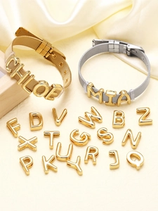 Detailed view of DIY metal mesh bracelets with customizable gold letter charms and buckles
