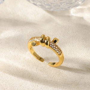 Macro shot of gold spiral ring with pavé-set zircons and elegant knotted design details