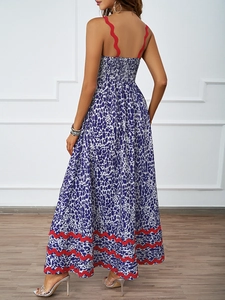 Detailed back view of a blue and white print maxi dress with red scalloped shoulder straps