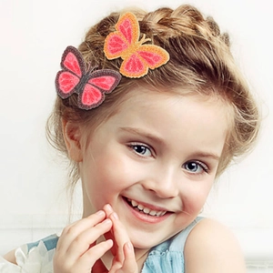 Close-up of glitter butterfly hair clips on child model side hair accessories