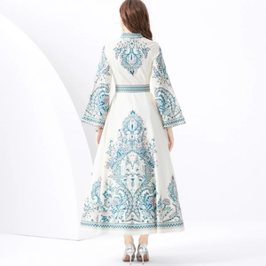 Resort style cream maxi dress with ethnic print, stand collar and flared sleeves, back view