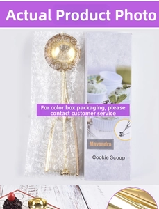 Detailed view of the gold 304 stainless steel cookie scoop in its purple gift box packaging