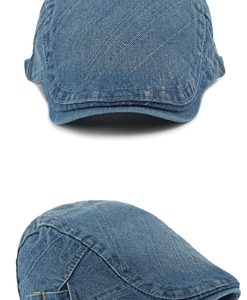 Close-up of washed denim flat cap showing twill texture and metal adjustment buckle