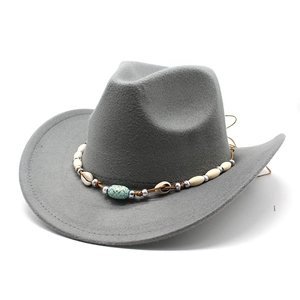 Close-up of gray felt cowboy hat featuring bohemian shell and turquoise bead band