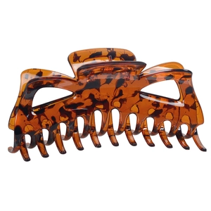 Large tortoiseshell hair claw clip in amber and brown resin for women's updos