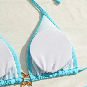 Detail of light blue bikini top with white mesh lining, removable pads and starfish charm