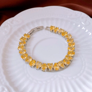 Detail of yellow pear-cut crystal bracelet with silver prongs and folding clasp