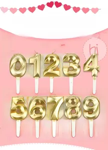 Detailed view of 3D geometric gold number candles set with stakes for birthday cakes