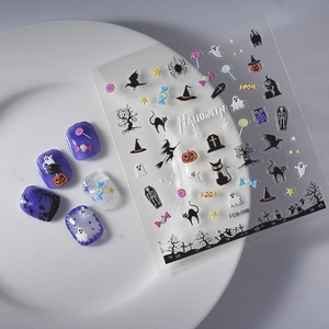 Halloween nail stickers set with pumpkins and ghosts patterns on a white ceramic plate