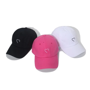 Detailed embroidery of small hearts on cotton baseball caps in black, pink and white
