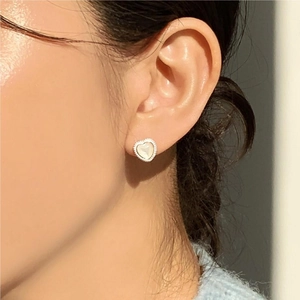 Elegant 925 sterling silver heart stud earrings with white shell inlay on model
