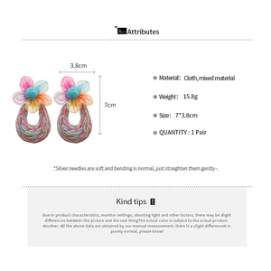 Detailed view of handmade floral raffia earrings with 7x3.8cm size and 15.8g weight
