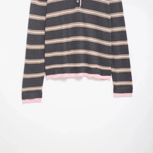 Striped knit polo shirt with grey, brown, and pink contrast trim on long sleeves