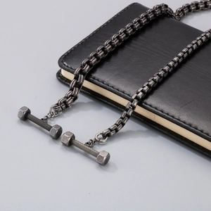 Vintage titanium steel barbell necklace with OT buckle on leather background