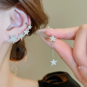 Detailed view of glittering star and moon tassel earrings set with zircon stones