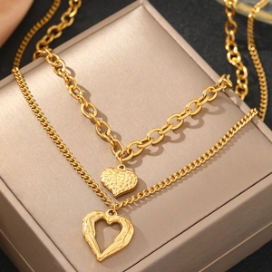 Elegant gold double layer stainless steel necklace featuring two textured heart pendants