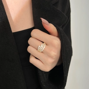 Close-up of four-layer gold-plated vine wrap ring with sparkling zircon pavé setting