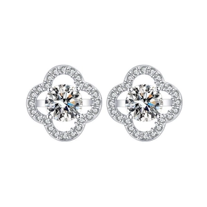 Macro view of four-leaf clover silver stud earrings with round moissanite center