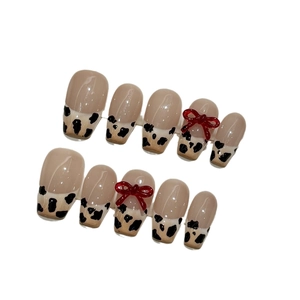 Handmade leopard milk tea press-on nails with 3D red bows and black polka dots