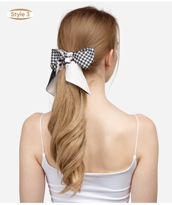 Detail of Style 3 black and white houndstooth hair ribbon on long blonde hair