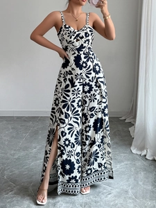 Detail view of black and white print jumpsuit featuring a cutout and side slit wide leg