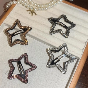 Set of four sparkling rhinestone star hair clips in gold, silver, purple, and grey finishes