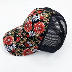 Side view of floral baseball cap with breathable black mesh back and curved brim