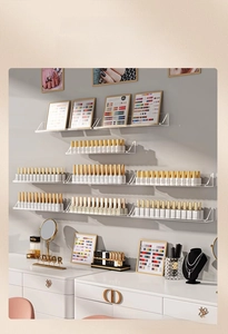 Macro view of clear acrylic wall-mounted nail polish rack with neat storage tiers
