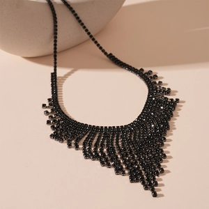 Close-up of luxury black rhinestone layered tassel necklace on elegant geometric props