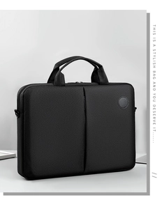 Minimalist black laptop bag detail showing durable fabric and vertical zipper pocket
