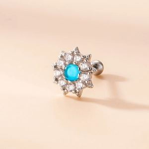 Macro shot of silver flower stud earring with blue turquoise and clear cubic zirconia