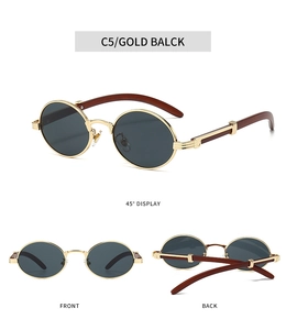 Close-up detail of retro oval sunglasses with gold frame and mahogany wood grain temples