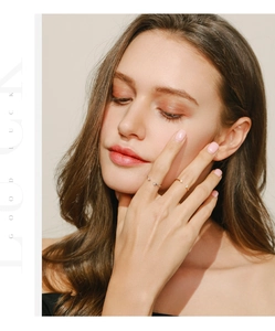 Close-up of minimalist silver and gold open rings with dual zircon stones on model's hand