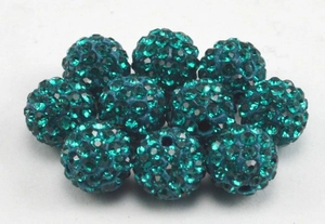 Close-up of peacock blue pave clay disco beads with sparkling rhinestones for jewelry DIY